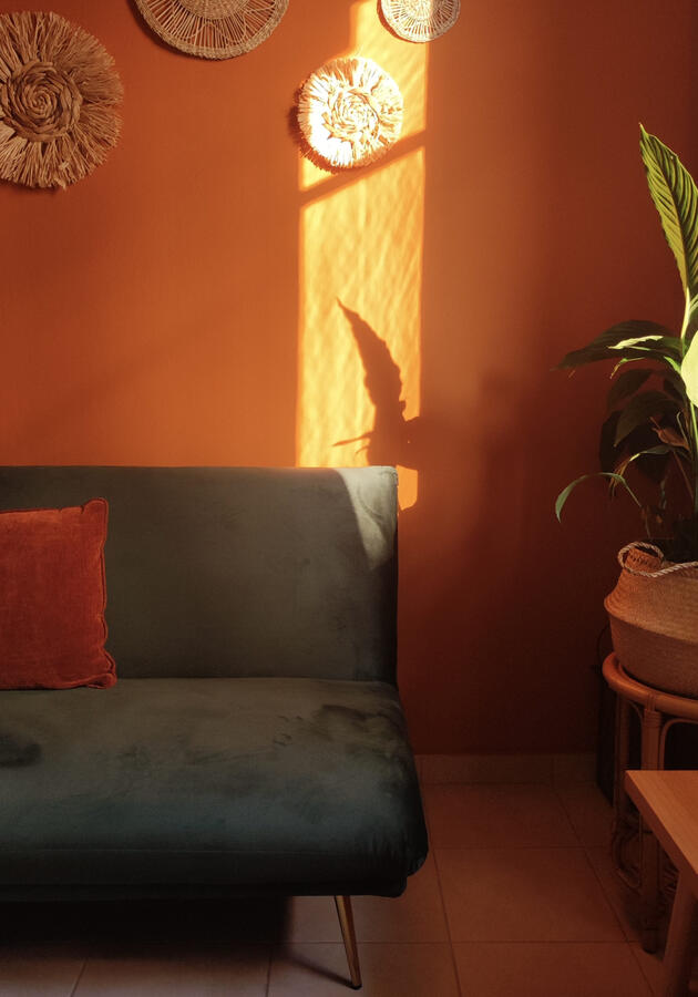 The terracotta colored living room of Hermanas Yoga studio in Sparta, Greece.